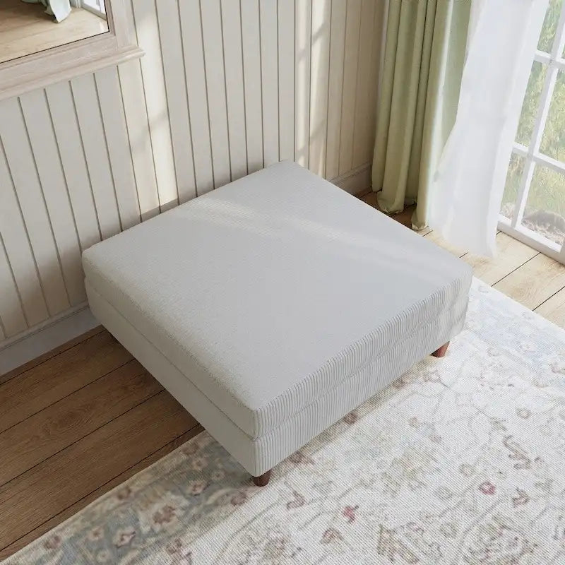 Ottoman moderno rivestito in velluto a coste con gambe in legno